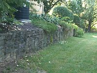 Retaining wall now showing its natural rock colors.