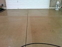 Driveway in process of being cleaned. Left side has been cleaned.