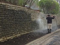 Stone wall being cleaned for local HOA in Kettering.